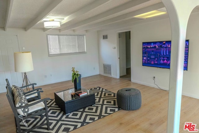 living room with hardwood / wood-style flooring and a textured ceiling