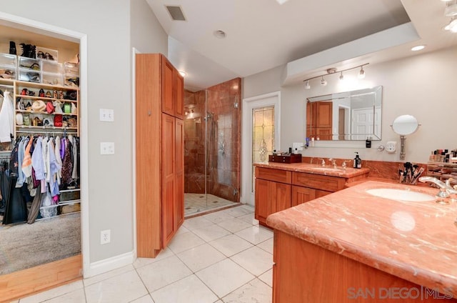 bathroom with vanity, an enclosed shower, and tile patterned flooring