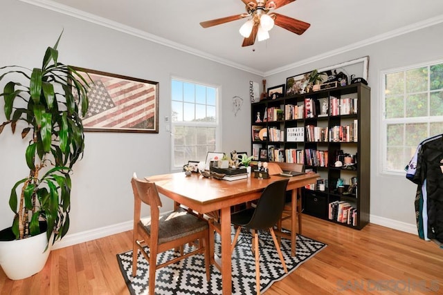 dining space with ceiling fan, ornamental molding, and hardwood / wood-style floors