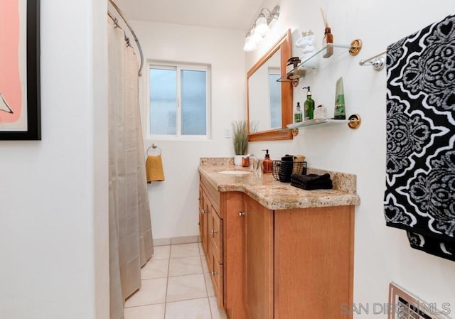 bathroom featuring tile patterned flooring and vanity