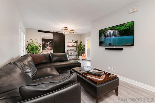 living room with a healthy amount of sunlight, hardwood / wood-style floors, and ceiling fan