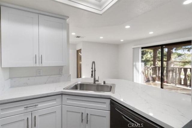 kitchen with dishwasher, sink, white cabinets, and light stone counters