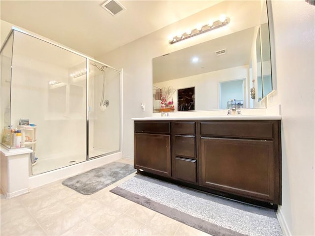 bathroom with vanity and a shower with door