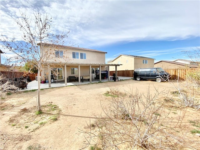 back of property with a patio