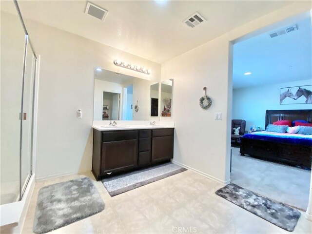 bathroom with vanity and a shower with shower door