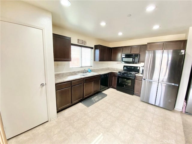 kitchen featuring sink, dark brown cabinetry, and black appliances