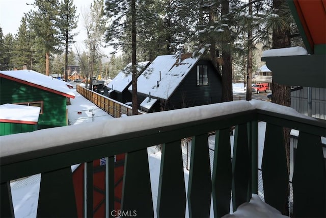 view of snow covered back of property