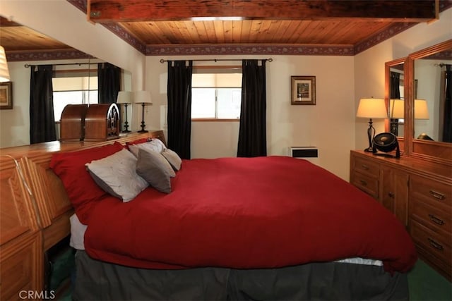 bedroom with multiple windows and wooden ceiling