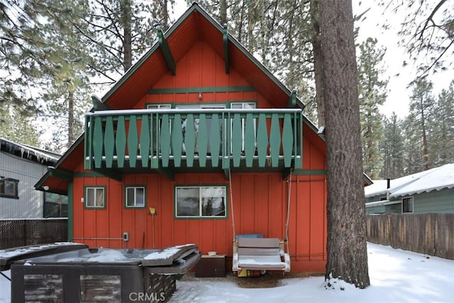 view of snow covered rear of property