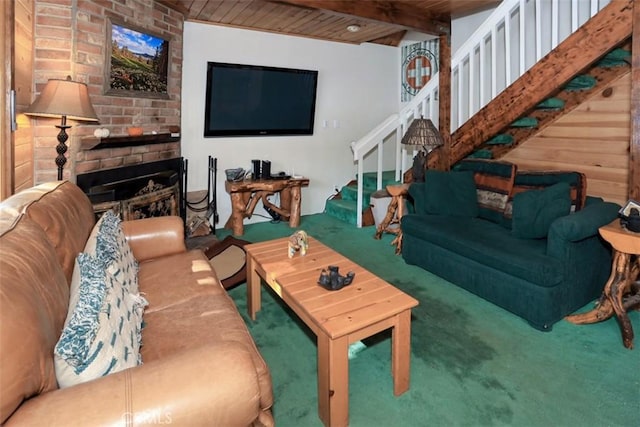 carpeted living room with beam ceiling, a brick fireplace, and wood ceiling