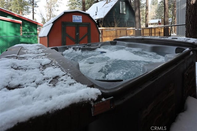 yard layered in snow featuring a hot tub