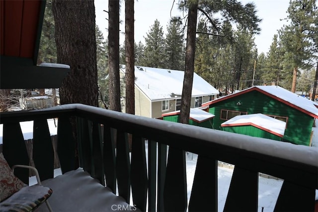 view of snow covered back of property