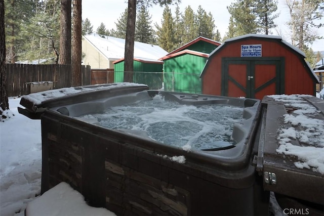 snowy yard with a hot tub