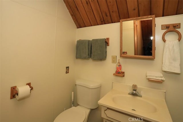 bathroom featuring vanity, lofted ceiling, wooden ceiling, and toilet