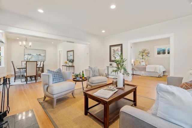 living room with a chandelier and light wood-type flooring