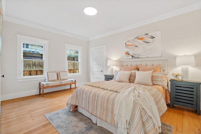 bedroom with light hardwood / wood-style flooring and ornamental molding