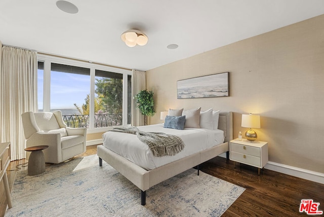 bedroom with dark hardwood / wood-style floors