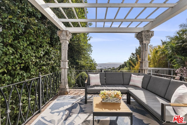 view of patio with a balcony, an outdoor living space, and a pergola