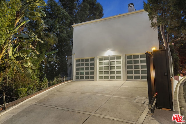 back of house featuring a garage