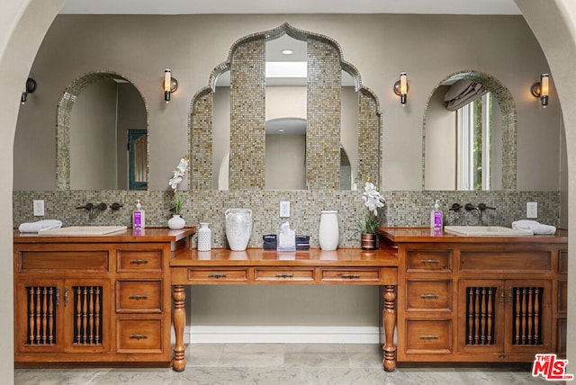 bathroom featuring vanity and backsplash