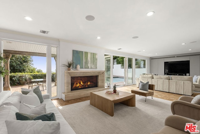 living room with light parquet flooring and a fireplace