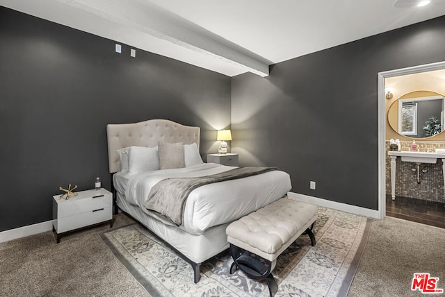 bedroom featuring sink, carpet floors, and ensuite bathroom