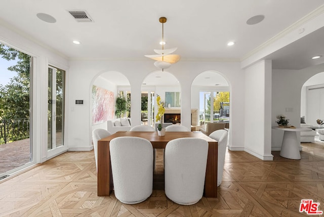 dining room featuring crown molding and light parquet floors