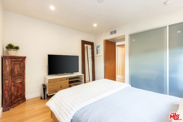 bedroom with light hardwood / wood-style floors