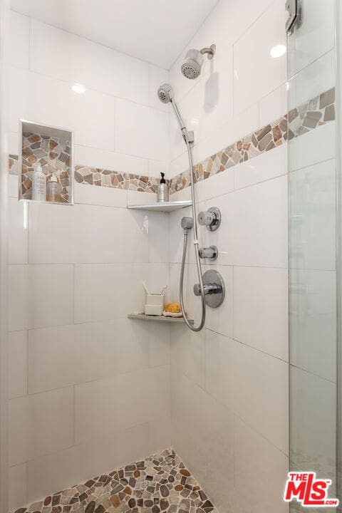 bathroom with a tile shower