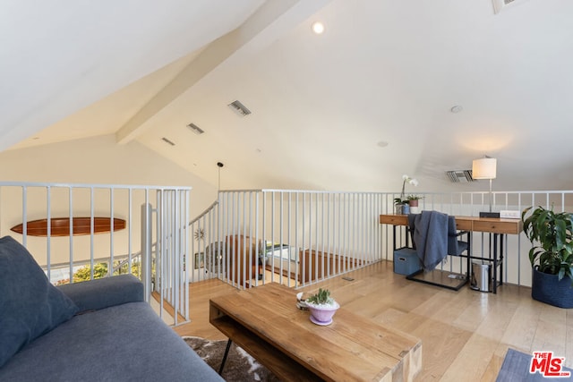 living room with lofted ceiling with beams and light hardwood / wood-style floors