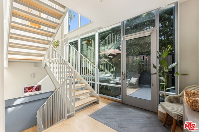 interior space with expansive windows and hardwood / wood-style flooring