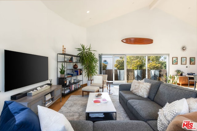 living room featuring beamed ceiling, high vaulted ceiling, and hardwood / wood-style flooring