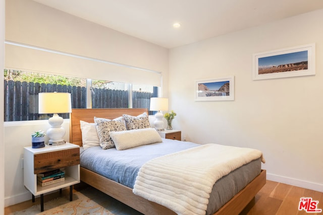 bedroom with hardwood / wood-style flooring