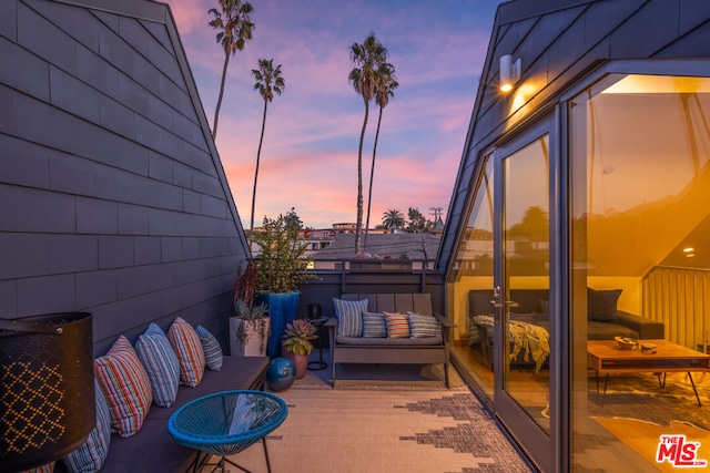 balcony at dusk featuring outdoor lounge area