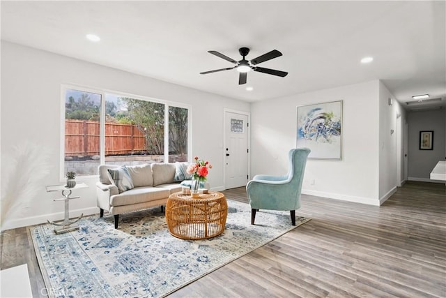 living room featuring hardwood / wood-style flooring and ceiling fan