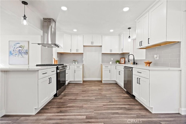 kitchen featuring hanging light fixtures, appliances with stainless steel finishes, island range hood, and white cabinets