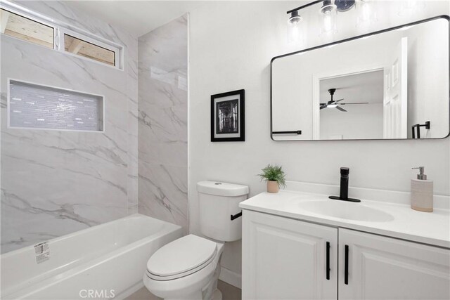 full bathroom with ceiling fan, tiled shower / bath, vanity, and toilet