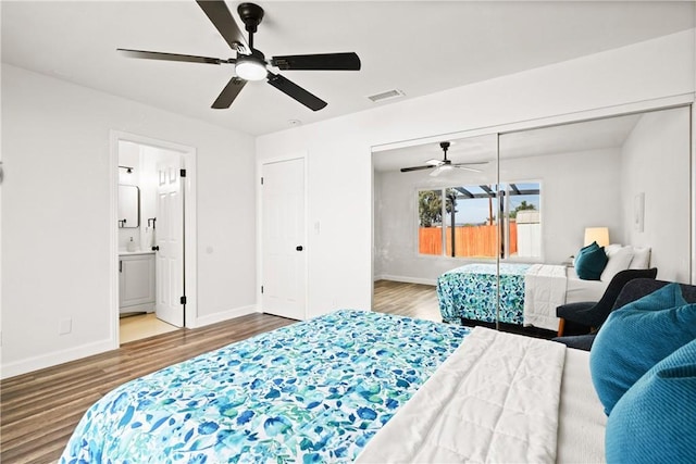 bedroom with hardwood / wood-style flooring, a closet, ceiling fan, and ensuite bathroom