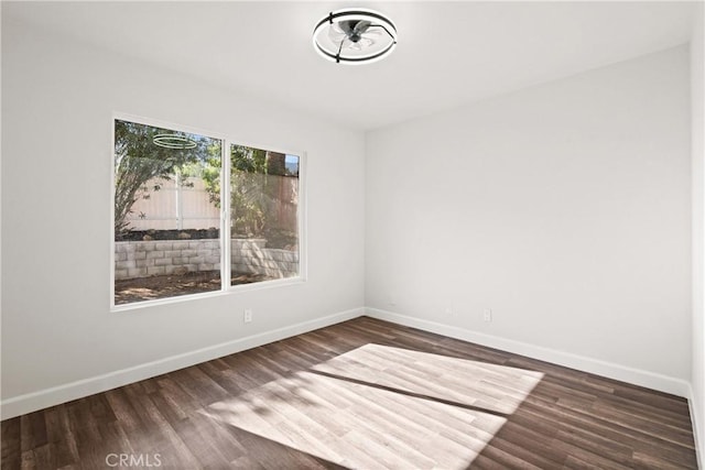 spare room featuring dark wood-type flooring