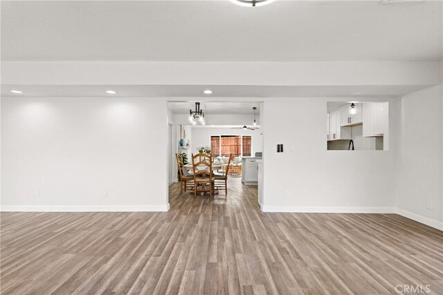 unfurnished living room with light hardwood / wood-style floors and ceiling fan