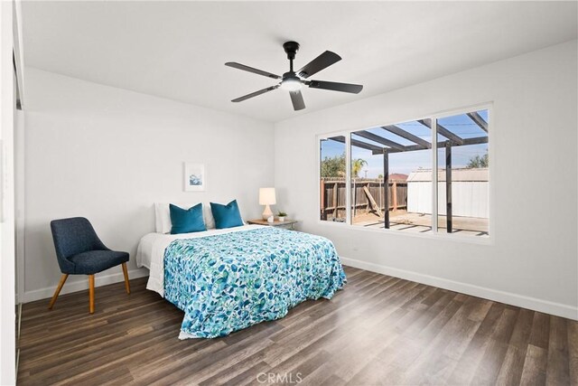 bedroom with dark hardwood / wood-style flooring and ceiling fan