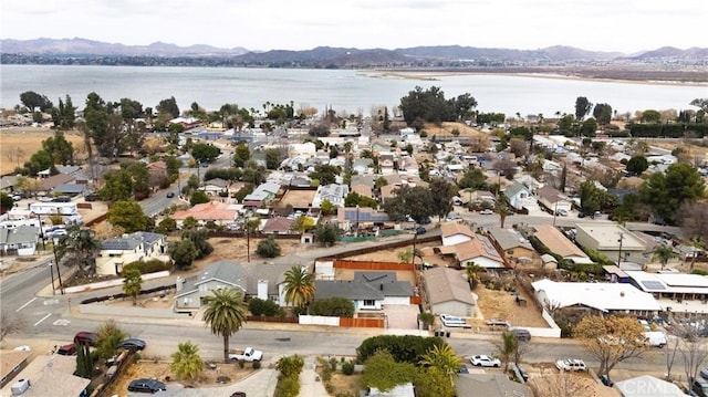 birds eye view of property with a water and mountain view