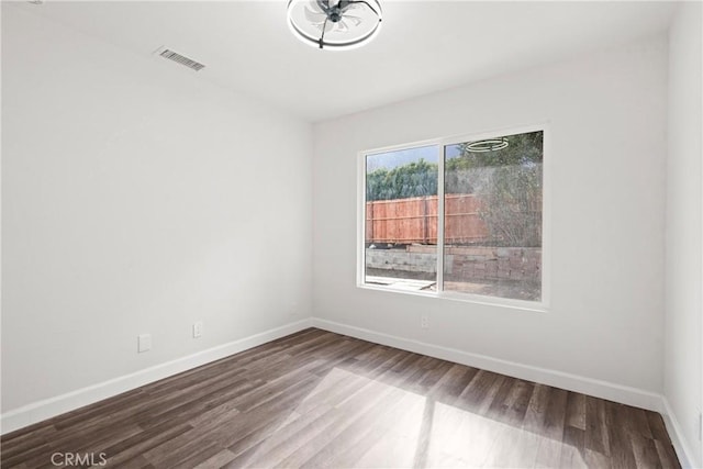 spare room with hardwood / wood-style flooring