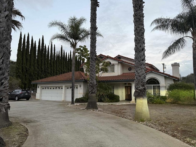 mediterranean / spanish house with a garage