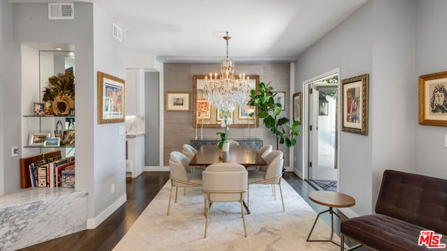 dining area featuring a notable chandelier and hardwood / wood-style flooring