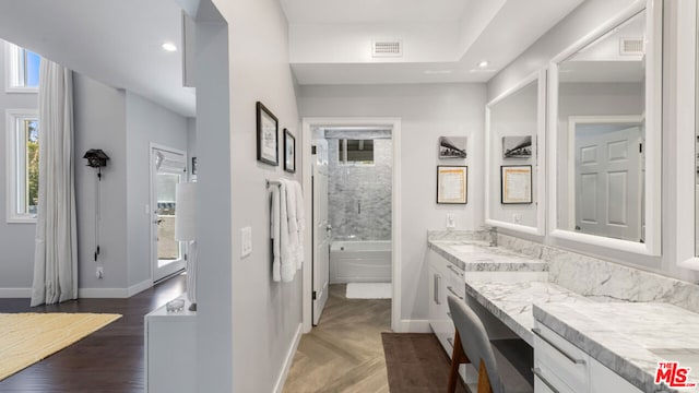 bathroom with vanity, a bathtub, and hardwood / wood-style floors