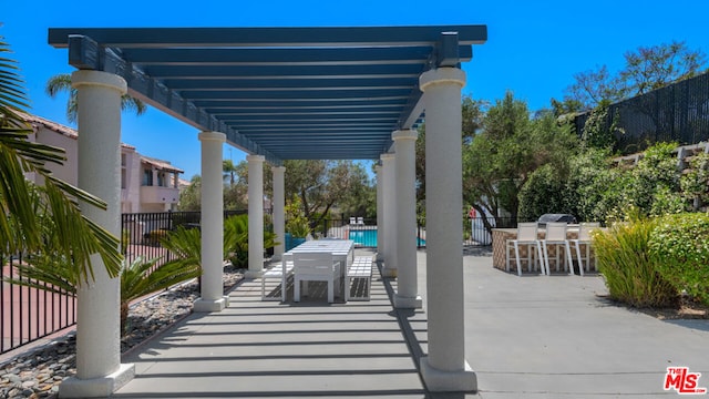 view of patio / terrace featuring a bar and a pergola