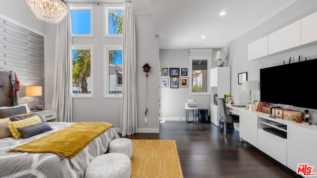 bedroom with dark hardwood / wood-style flooring and a chandelier