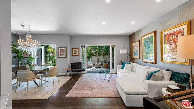 living room with dark wood-type flooring and a chandelier