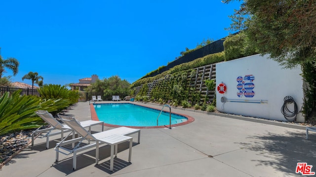 view of swimming pool with a patio